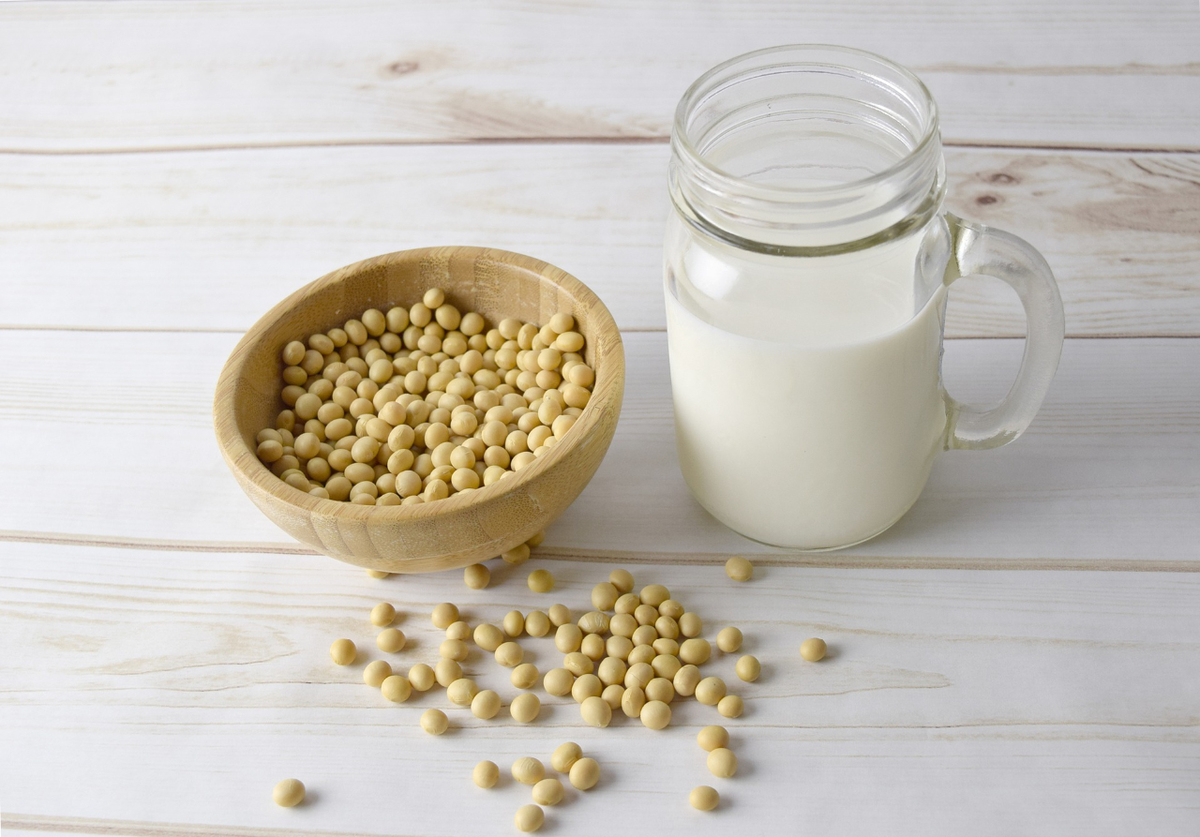 Bowl of soybeans and glass of soy milk